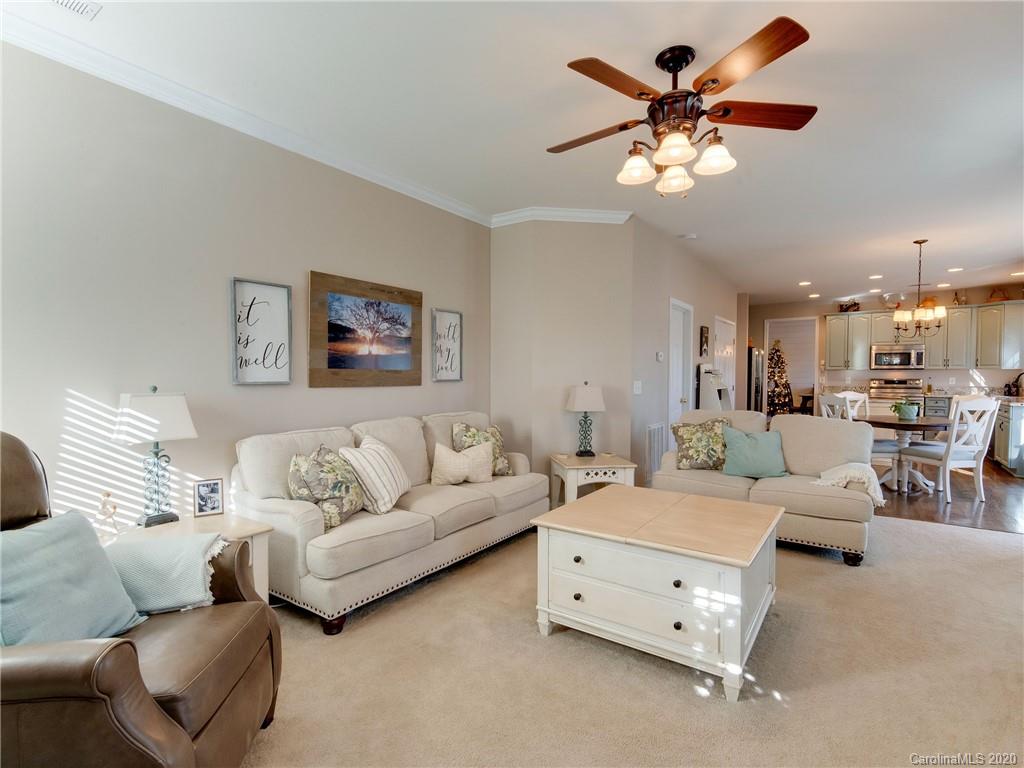 3028 Strawberry Road Matthews, NC 28104 - Photo 23 of 44 a living room with furniture and a chandelier