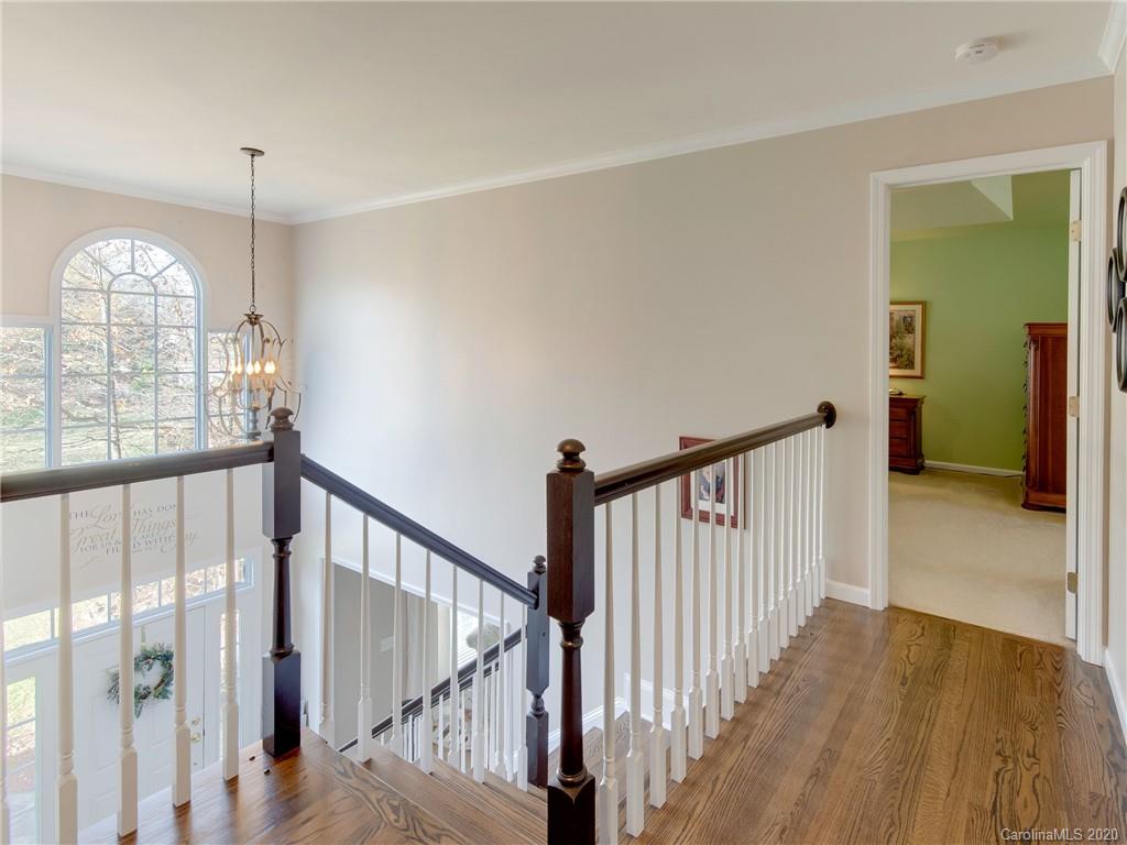 3028 Strawberry Road Matthews, NC 28104 - Photo 25 of 44 a view of a hallway with wooden floor door and windows