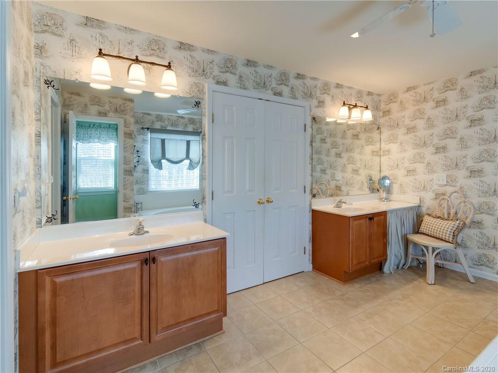 3028 Strawberry Road Matthews, NC 28104 - Photo 28 of 44 a bathroom with a sink double vanity and a mirror