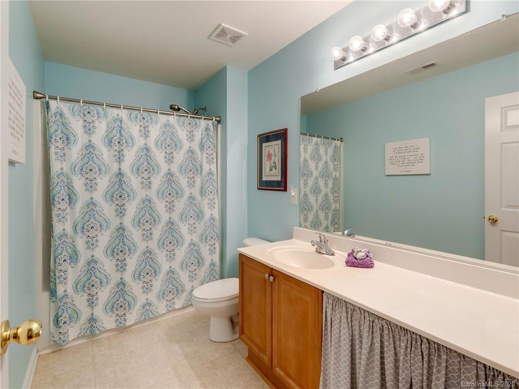 3028 Strawberry Road Matthews, NC 28104 - Photo 31 of 44 a bathroom with a sink a toilet and shower curtain
