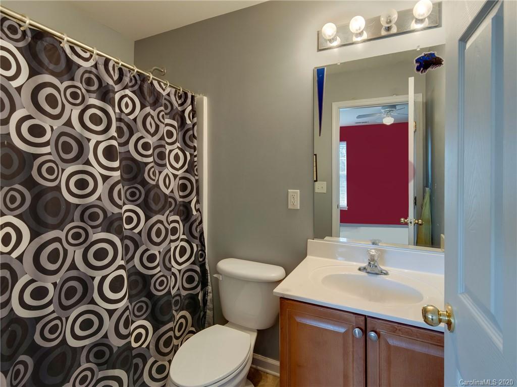 3028 Strawberry Road Matthews, NC 28104 - Photo 33 of 44 a bathroom with a sink and mirror with toilet