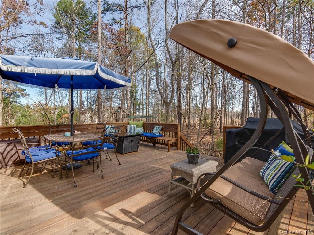 3028 Strawberry Road Matthews, NC 28104 - Photo 38 of 44 an outdoor sitting area with furniture and umbrella