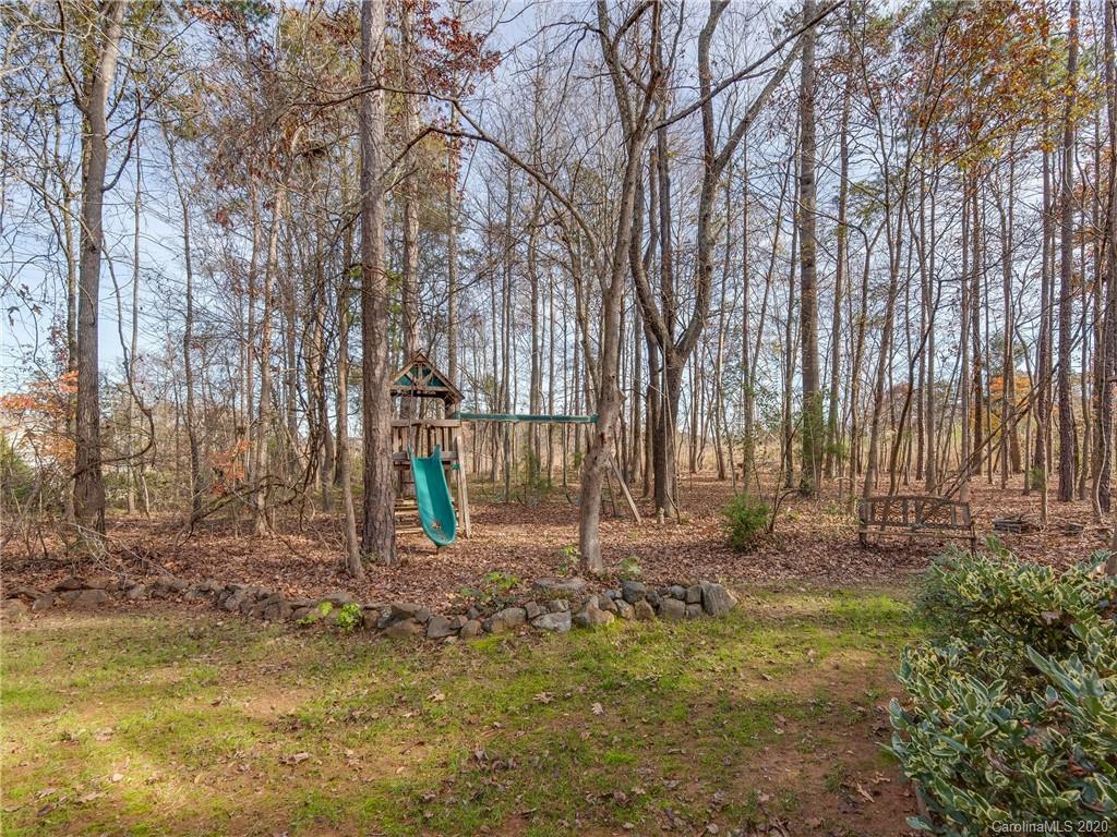 3028 Strawberry Road Matthews, NC 28104 - Photo 40 of 44 a backyard of a house with lots of green space