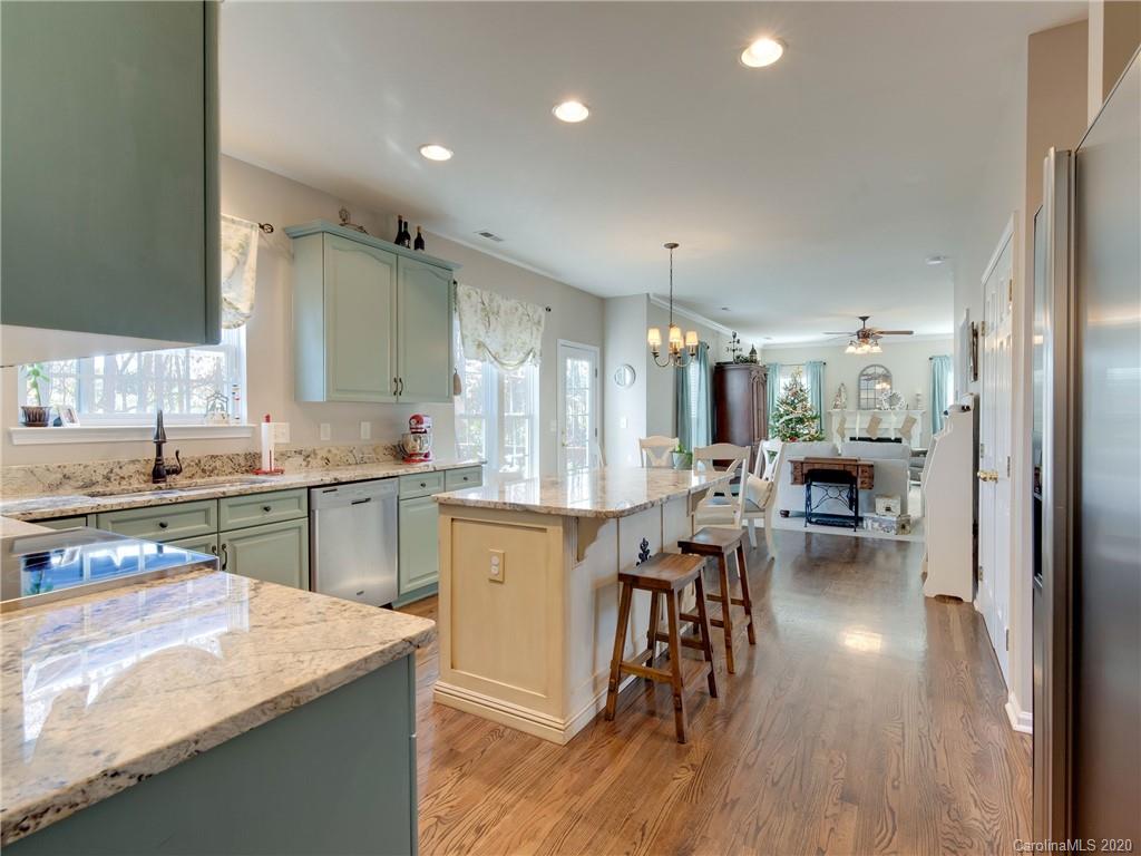 3028 Strawberry Road Matthews, NC 28104 - Photo 8 of 44 a kitchen with lots of counter top space and painting on the wall