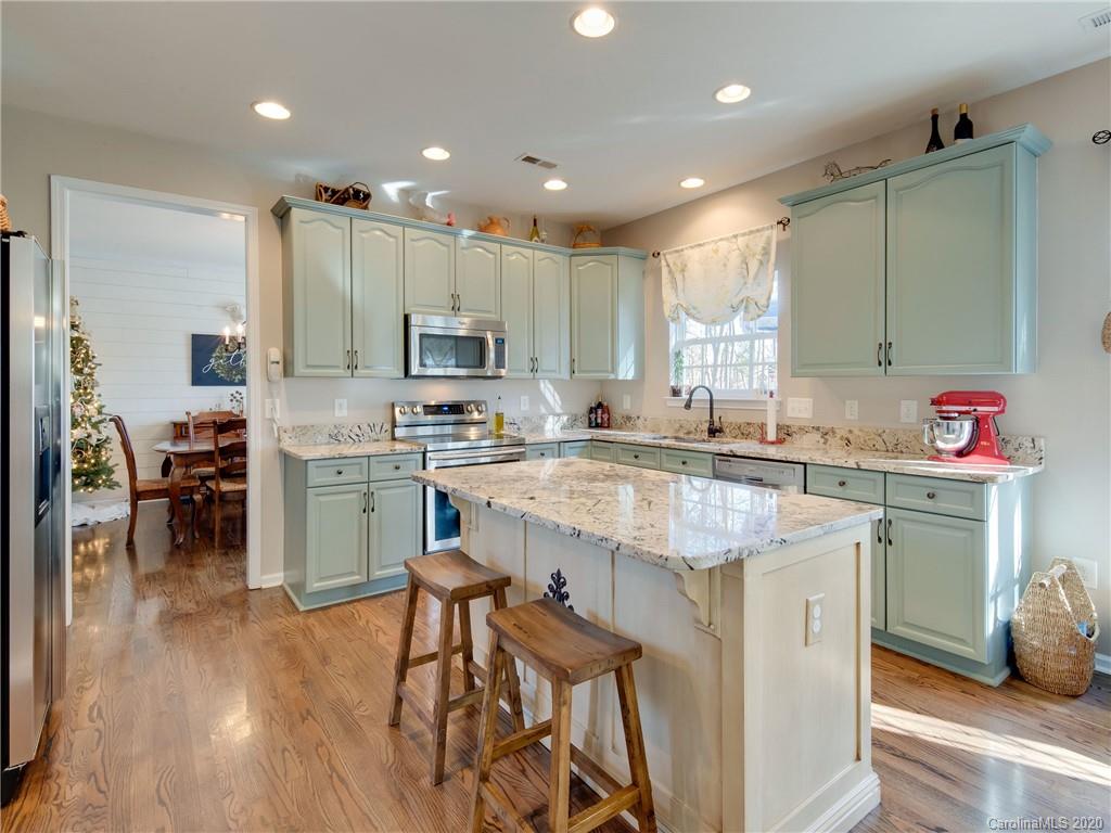 3028 Strawberry Road Matthews, NC 28104 - Photo 9 of 44 a kitchen with kitchen island granite countertop a sink counter and chairs