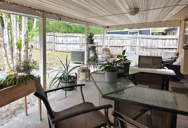 a view of a patio with table and chairs