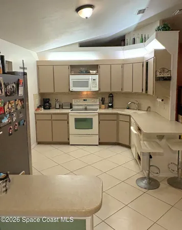 a kitchen with stainless steel appliances granite countertop a sink and a stove top oven
