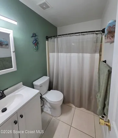 a bathroom with a sink a toilet a shower and a mirror