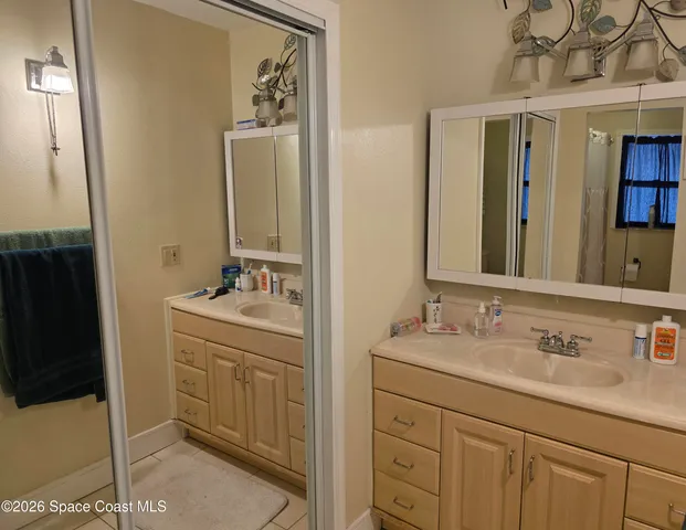a bathroom with a sink double vanity and a mirror