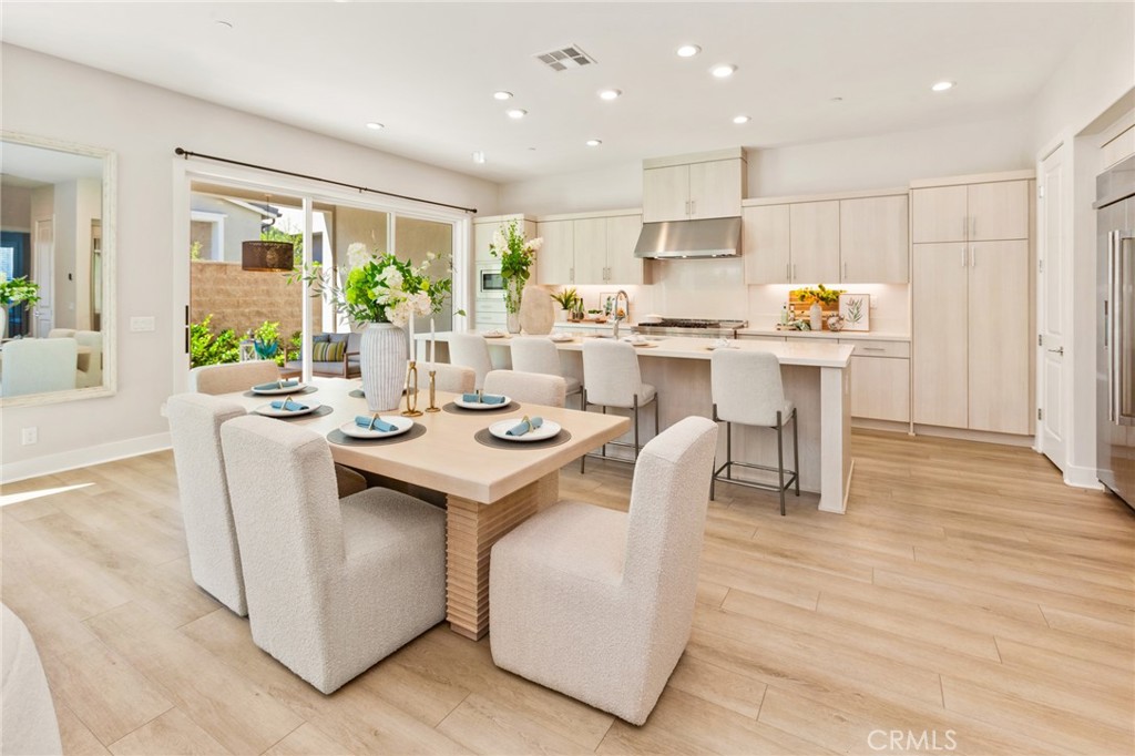 181 Mulberry Lake Forest, CA 92630 - Photo 14 of 46 a dining hall with stainless steel appliances kitchen island granite countertop a table chairs and a living room view
