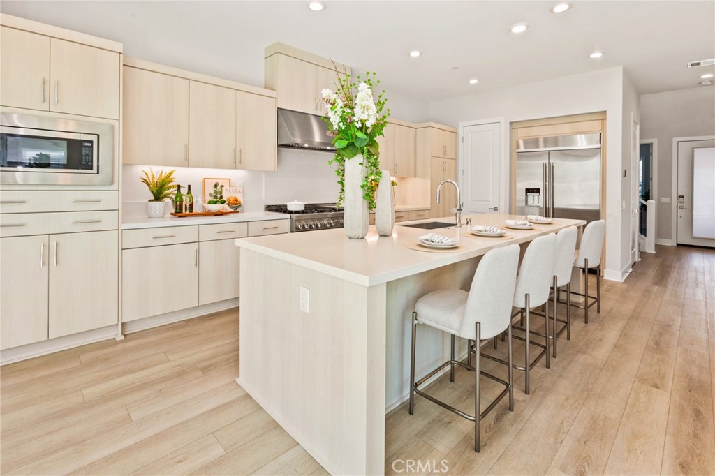 181 Mulberry Lake Forest, CA 92630 - Photo 19 of 46 a kitchen with stainless steel appliances kitchen island granite countertop a stove a sink a dining table and chairs