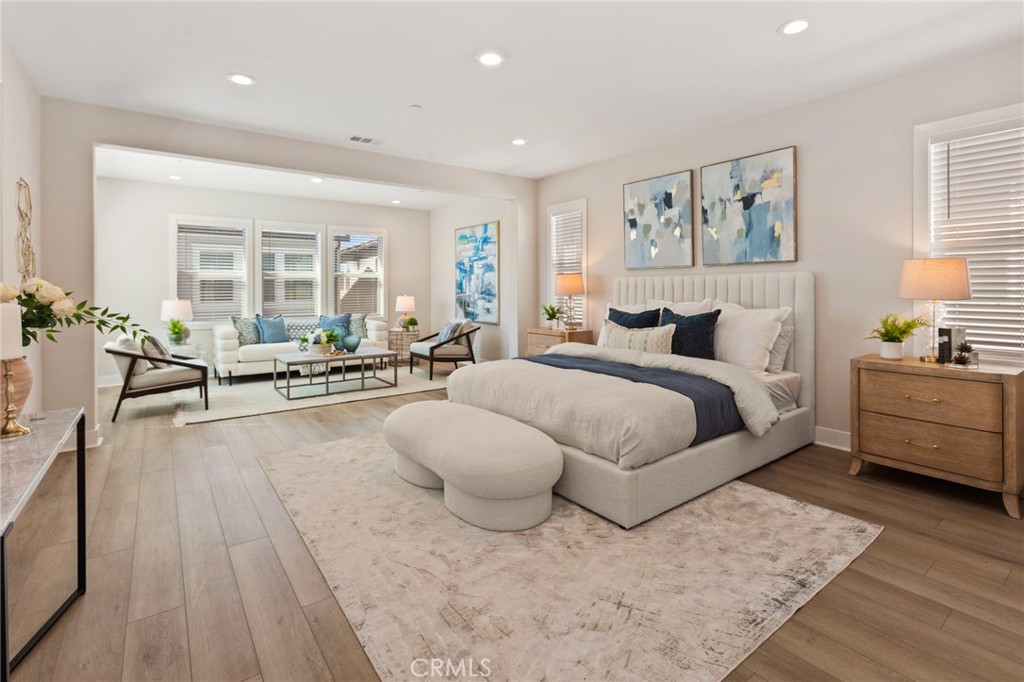 181 Mulberry Lake Forest, CA 92630 - Photo 23 of 46 a spacious bedroom with a bed a couch and a large window