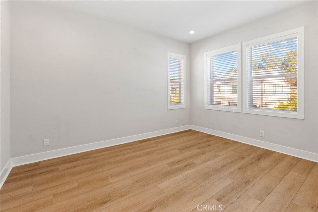 181 Mulberry Lake Forest, CA 92630 - Photo 36 of 46 an empty room with wooden floor and windows