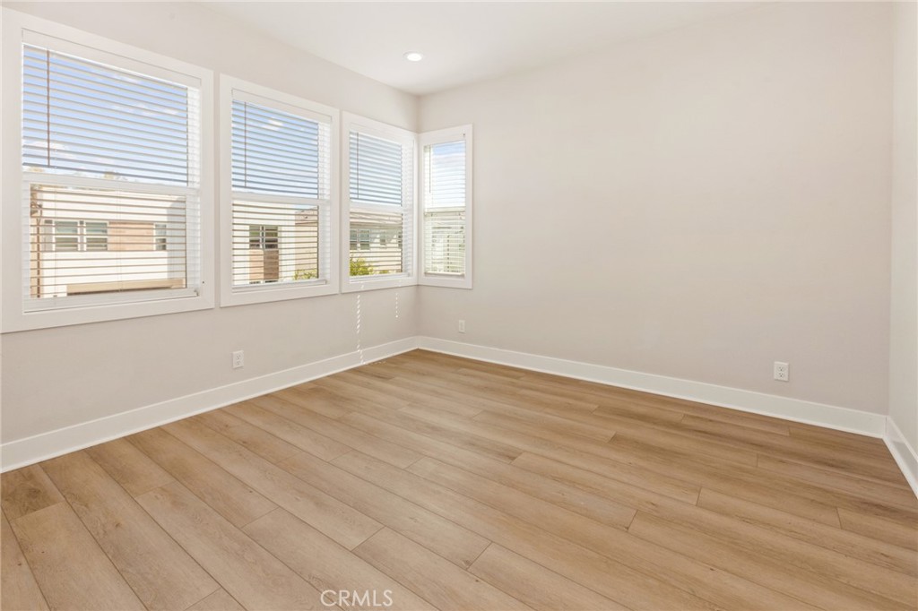 181 Mulberry Lake Forest, CA 92630 - Photo 39 of 46 an empty room with wooden floor and windows
