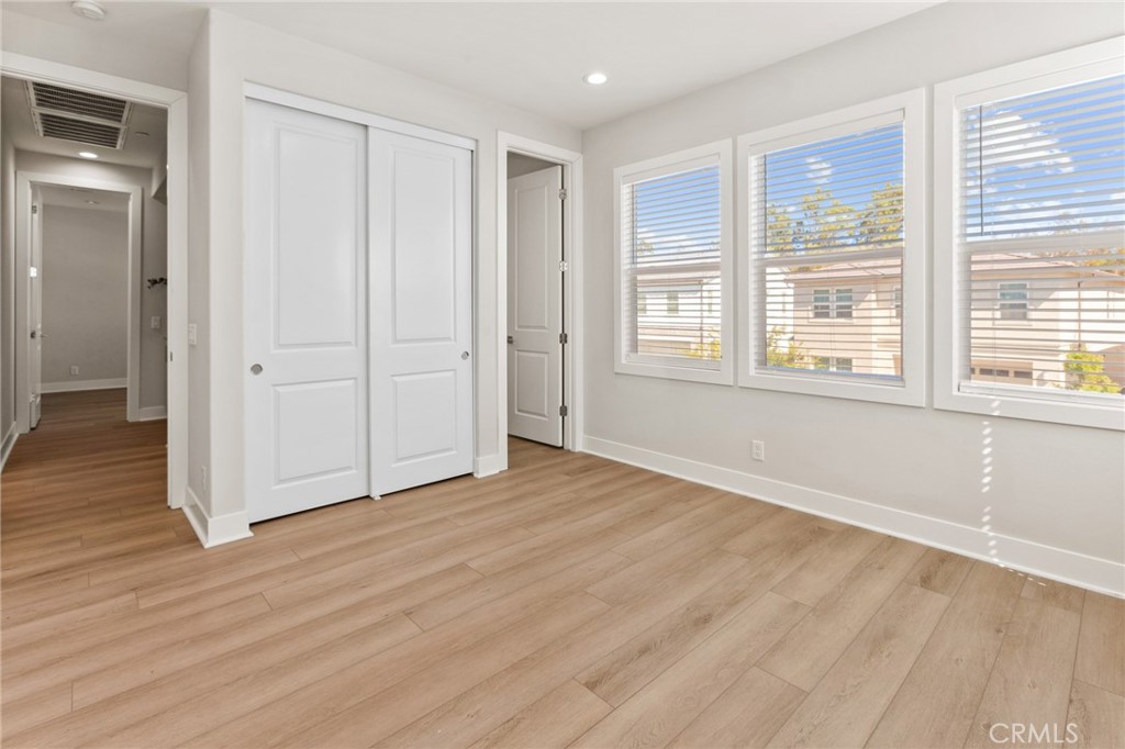 181 Mulberry Lake Forest, CA 92630 - Photo 40 of 46 a view of an empty room with wooden floor and a window