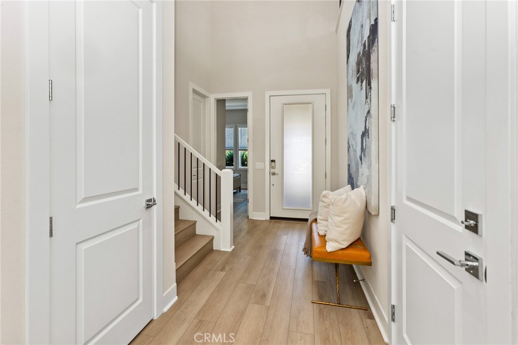 181 Mulberry Lake Forest, CA 92630 - Photo 6 of 46 a view of a hallway with wooden floor and a living room