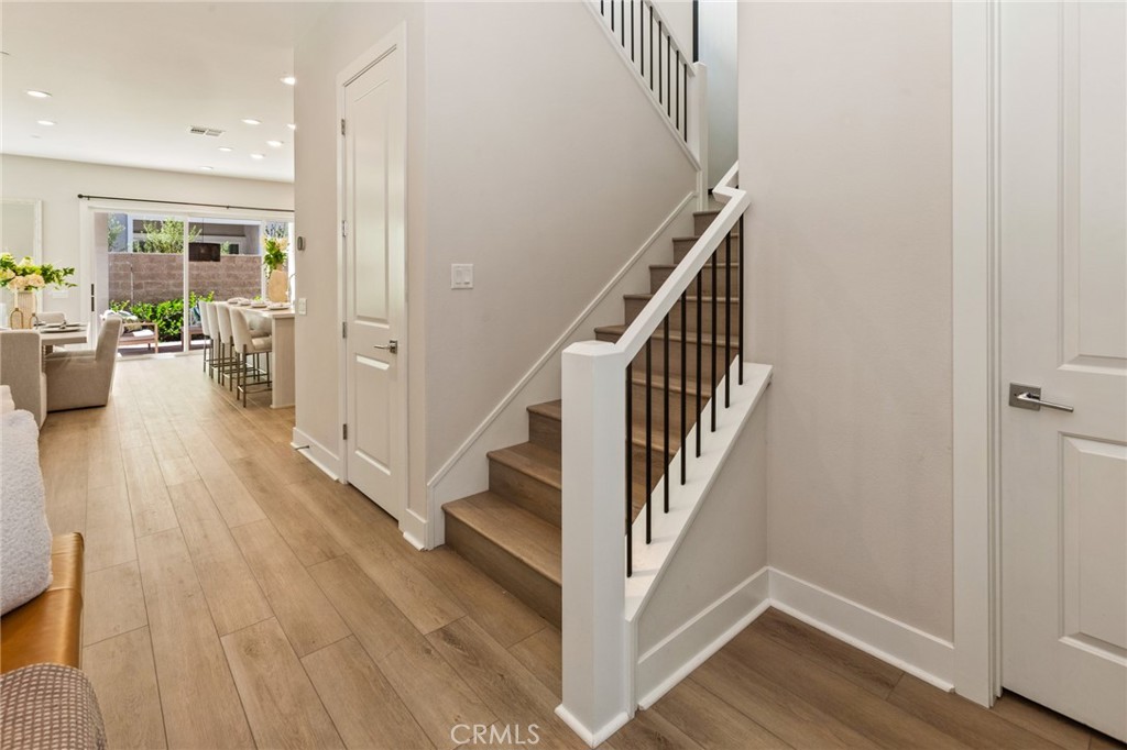 181 Mulberry Lake Forest, CA 92630 - Photo 7 of 46 a view of a hallway with wooden floor and stairs