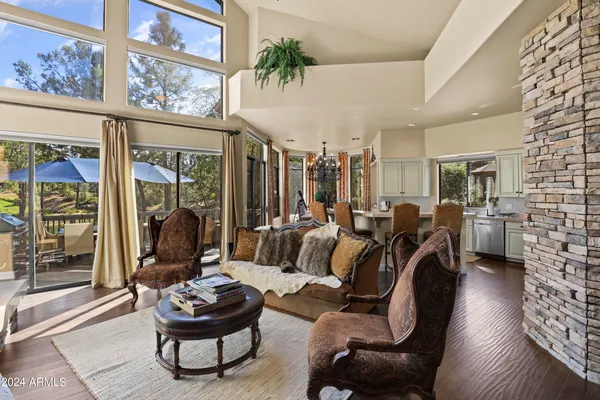 a living room with furniture wooden floor and a fireplace