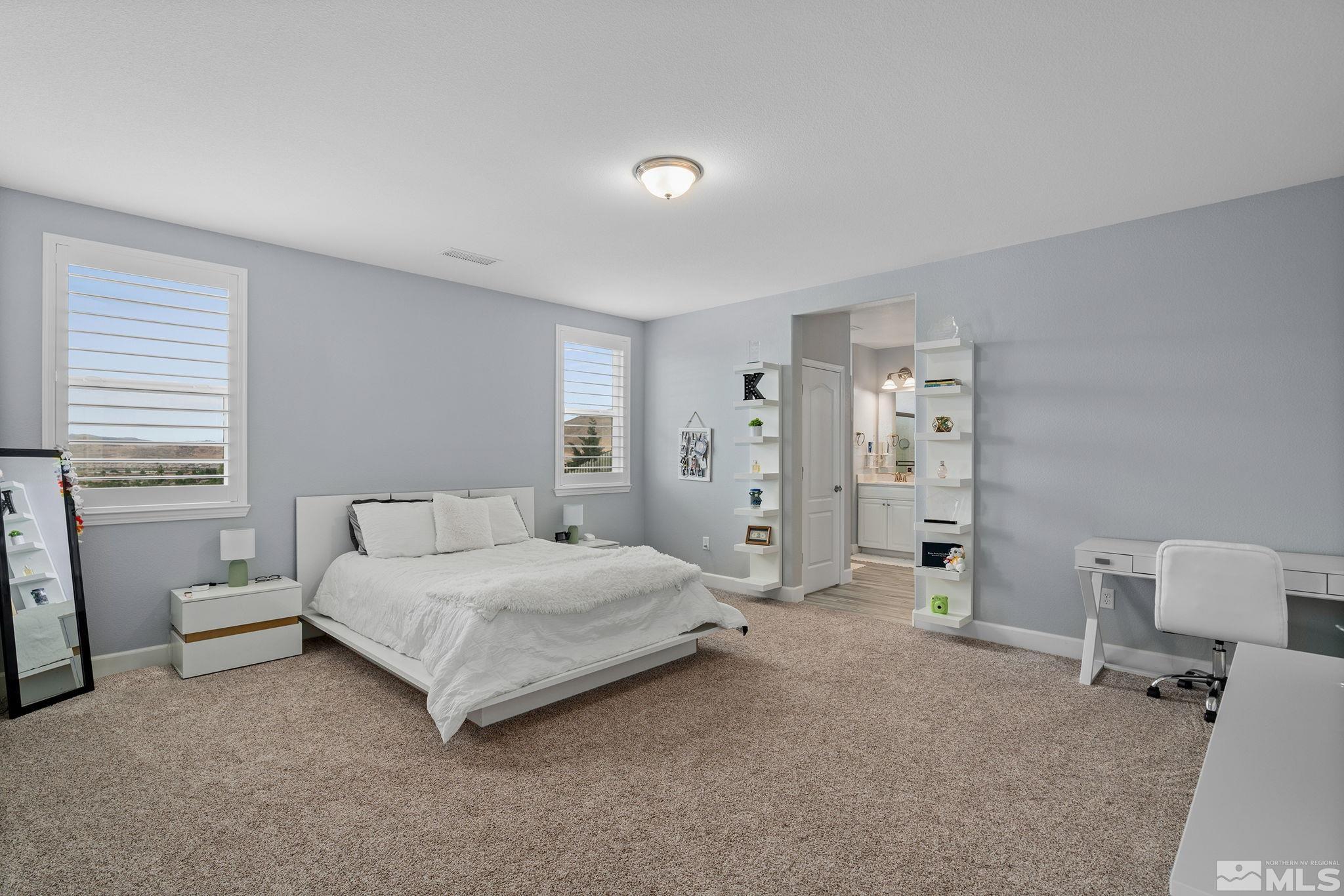 2811 McCauley Ranch Boulevard Reno, NV 89521 - Photo 27 of 40 a bedroom with a bed and a chair