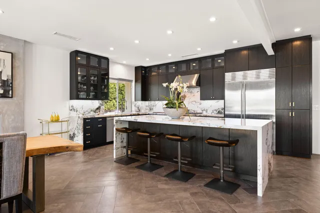 a kitchen with a sink a stove and wooden cabinets