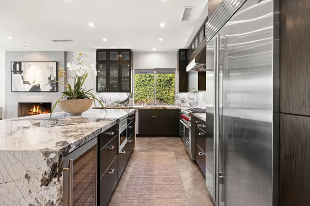 a dining room with furniture a fireplace and wooden floor