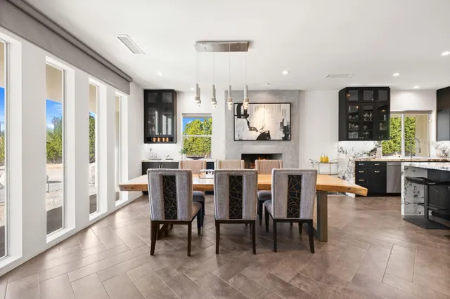 a spacious bedroom with a large bed and a chandelier