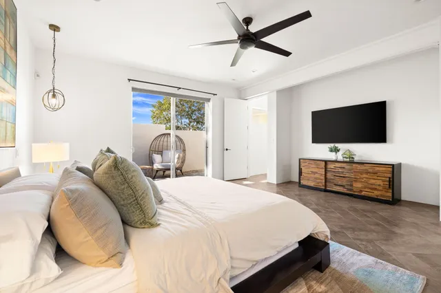 a bedroom with a large bed and a chandelier