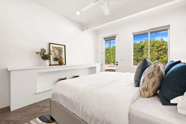 a bedroom with a bed a couch and a dresser