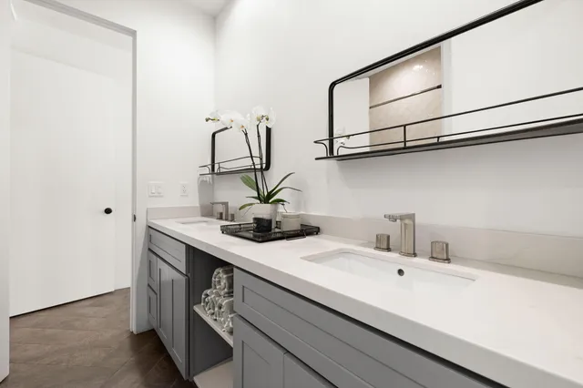 a bathroom with a sink a mirror and a shower