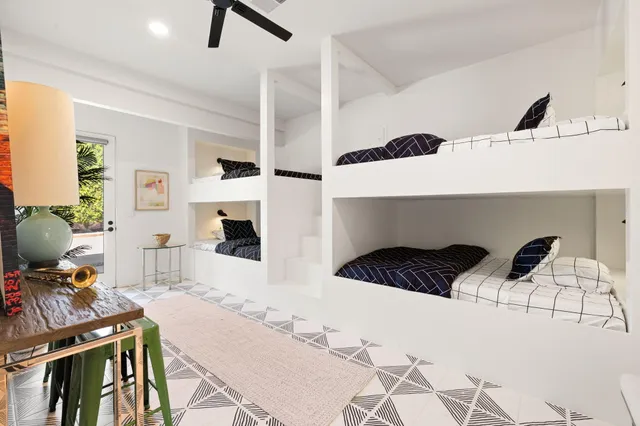 a living room with couches and kitchen view