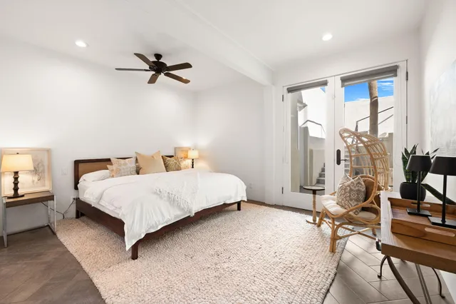 a bedroom with furniture and a flat screen tv