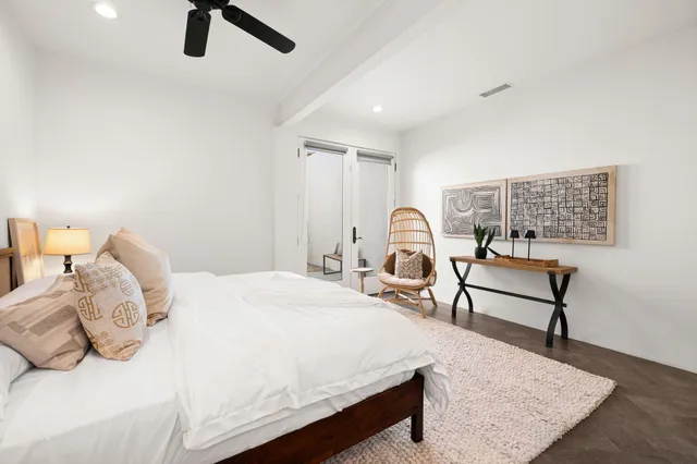 a bedroom with a bed and a large mirror