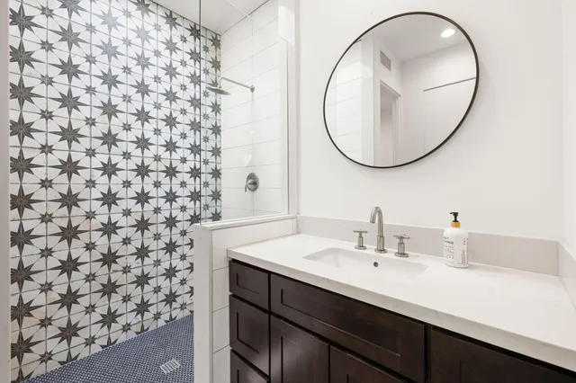 a bedroom with a bed and a painting on the wall