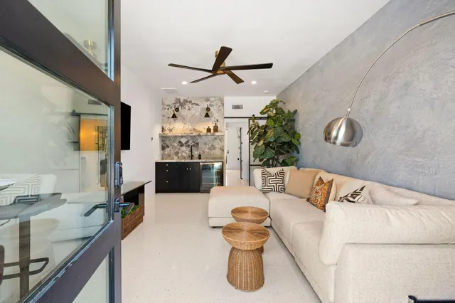 a view of a patio with table and chairs potted plants with wooden fence