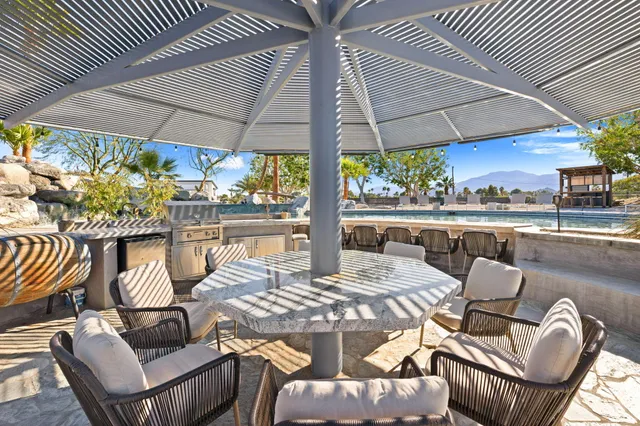 an aerial view of a swimming pool patio fireplace and outdoor seating