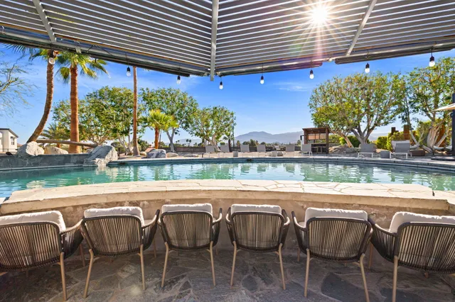 an aerial view of a house with a swimming pool