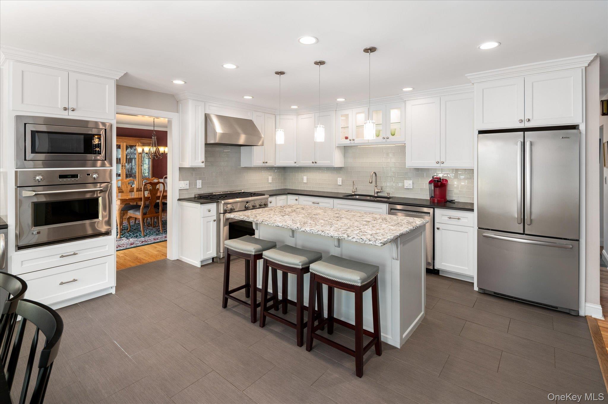 32 Watch Hill Road Croton-on-Hudson, NY 10520 - Photo 17 of 43 a kitchen with kitchen island a sink stainless steel appliances and cabinets