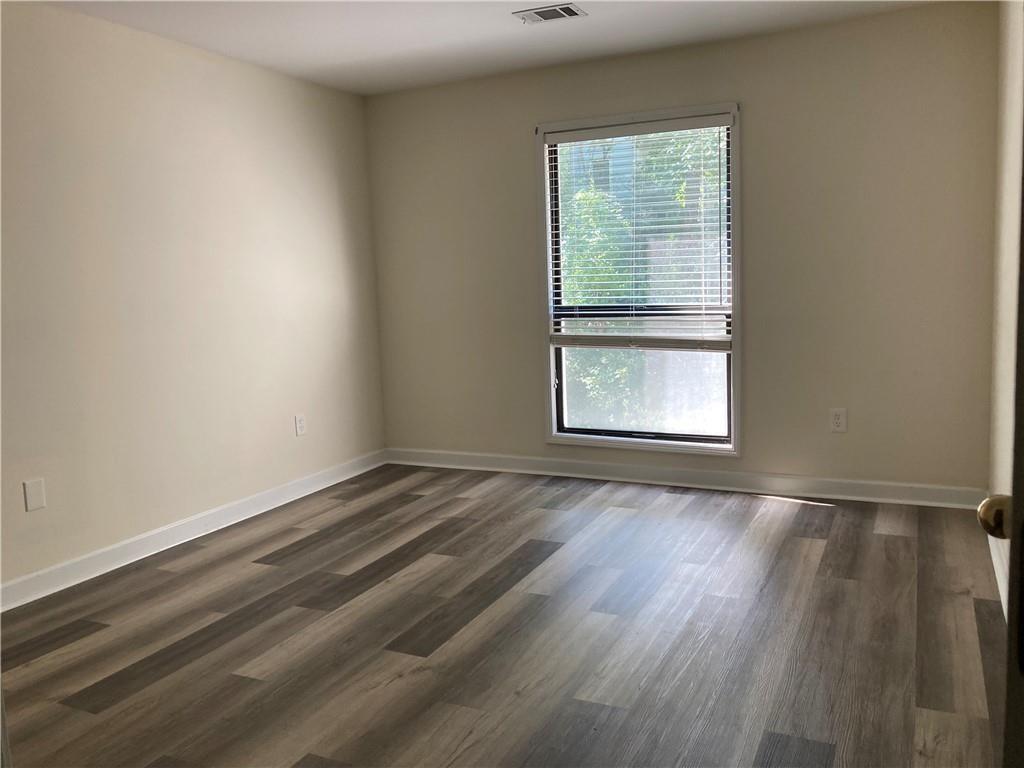 3203 Lenox Road Northeast, Unit 6 Atlanta, GA 30324 - Photo 14 of 27 an empty room with wooden floor and windows