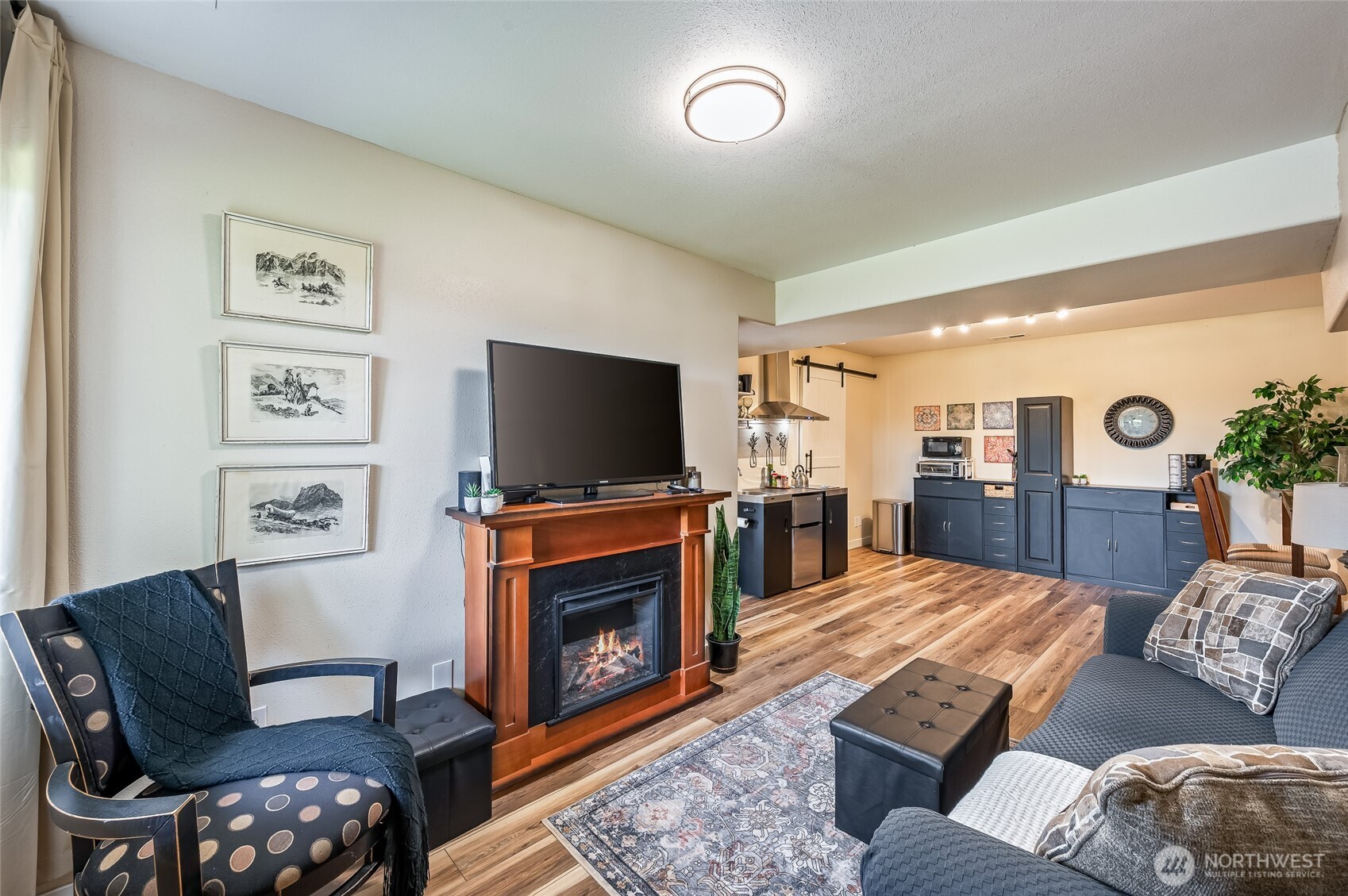 316 Easy Street Wenatchee, WA 98801 - Photo 30 of 39 a living room with furniture a flat screen tv and a fireplace
