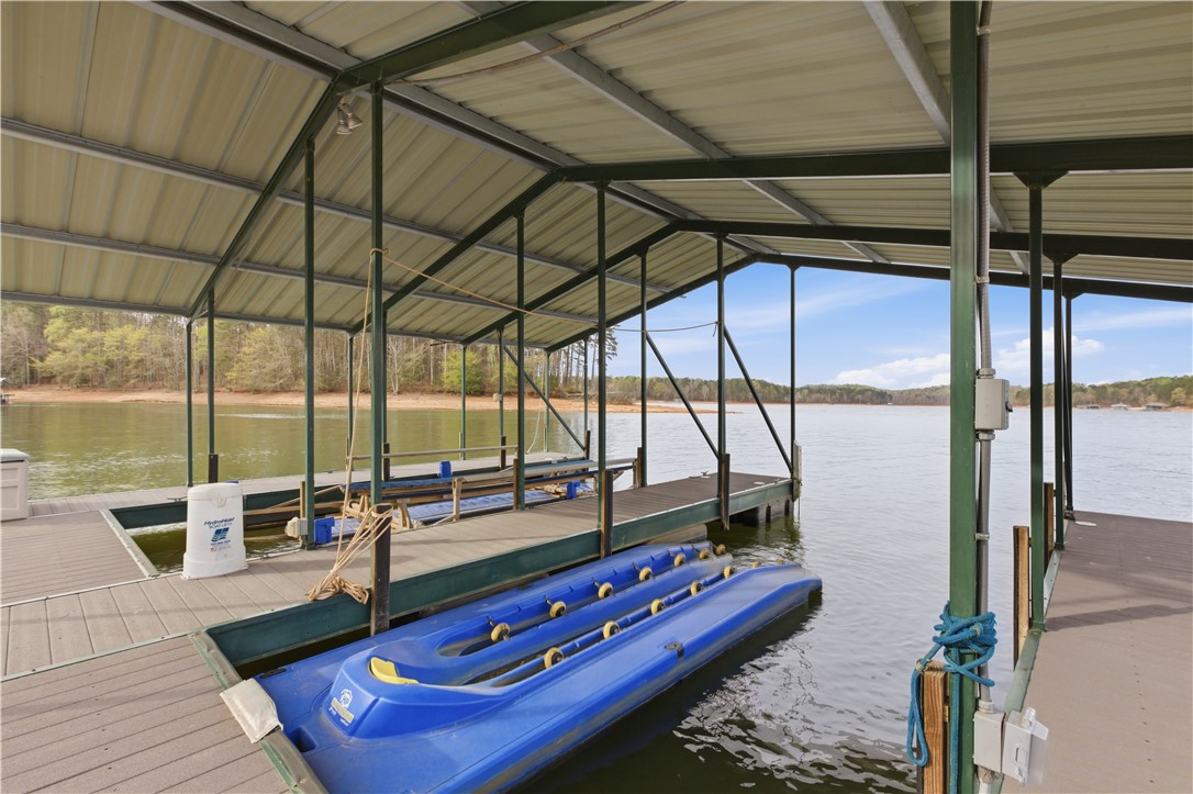 501 Capri Point Lavonia, GA 30553 - Photo 32 of 50 This serene lakefront property boasts a private covered dock, offering direct access to the water.