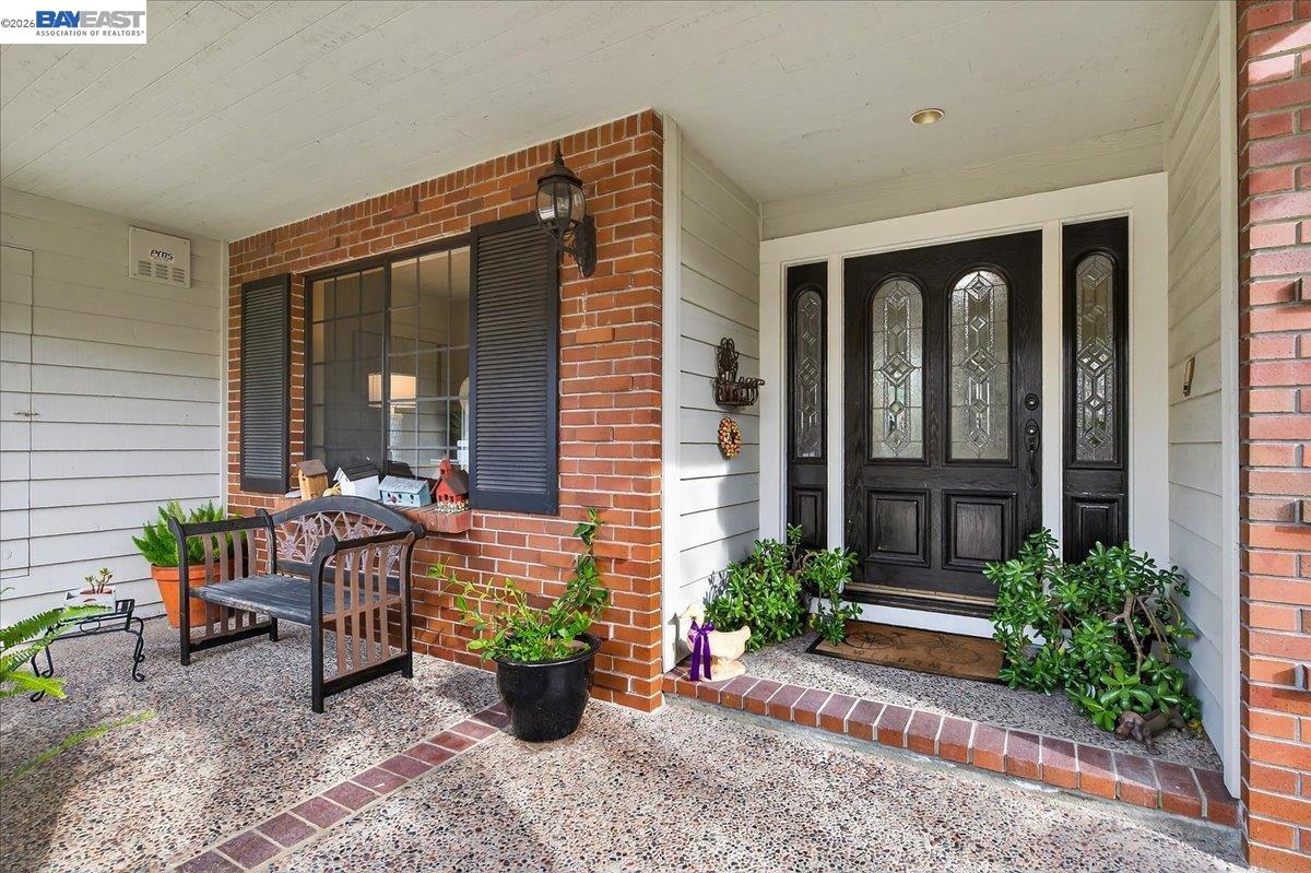 a view of a house with backyard sitting area and garden