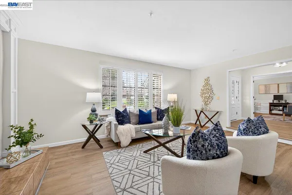 a living room with furniture and a potted plant