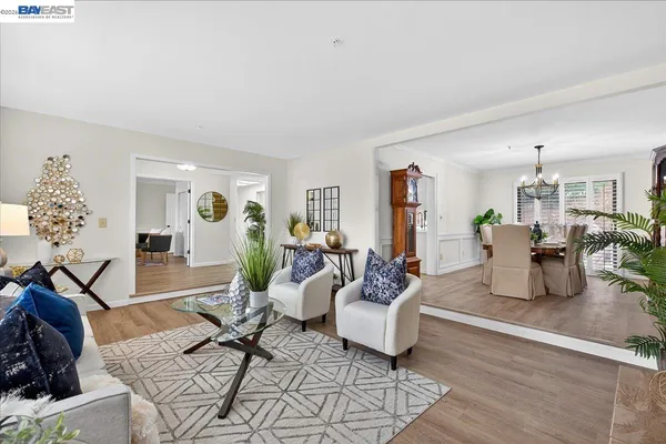a living room with furniture and flowers