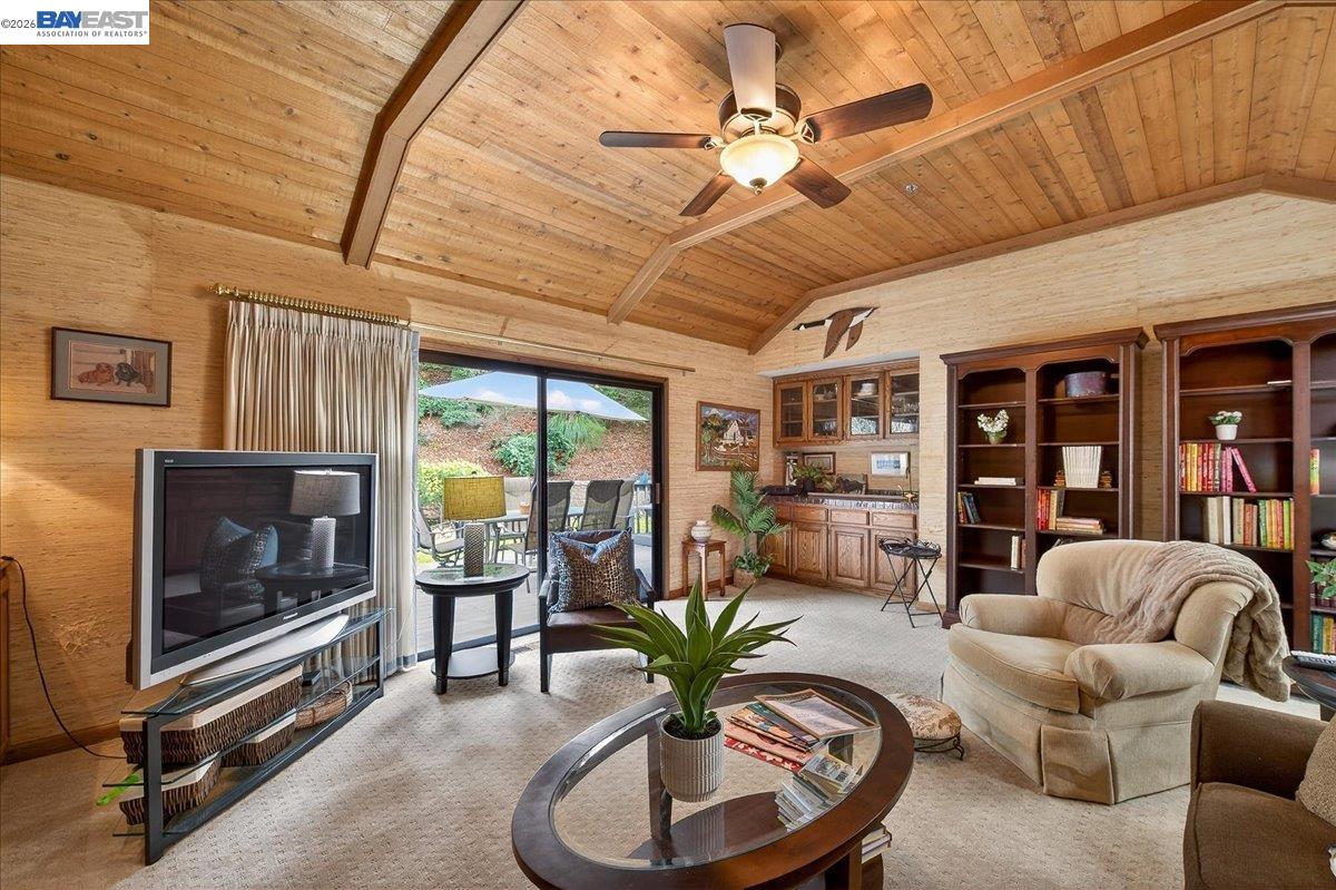 28 Harrington Road Moraga, CA 94556 - Photo 26 of 44 a living room with furniture a ceiling fan a flat screen tv and a large window