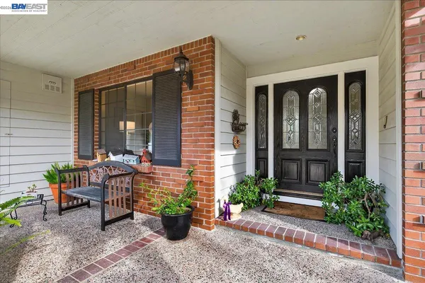 a view of a house with backyard sitting area and garden
