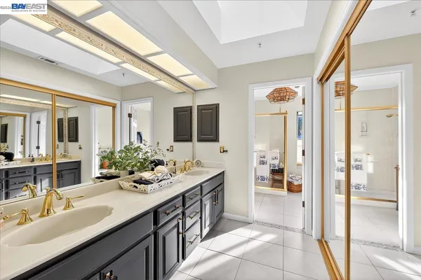 a spacious bathroom with a double vanity sink shower and mirror