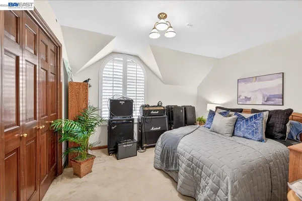 a bedroom with bed and a chandelier
