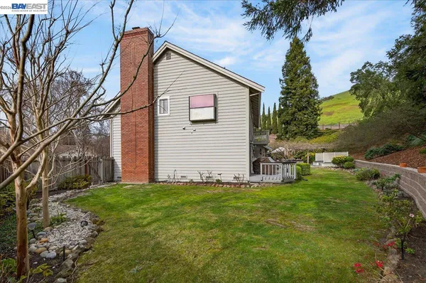a view of backyard of house with green space