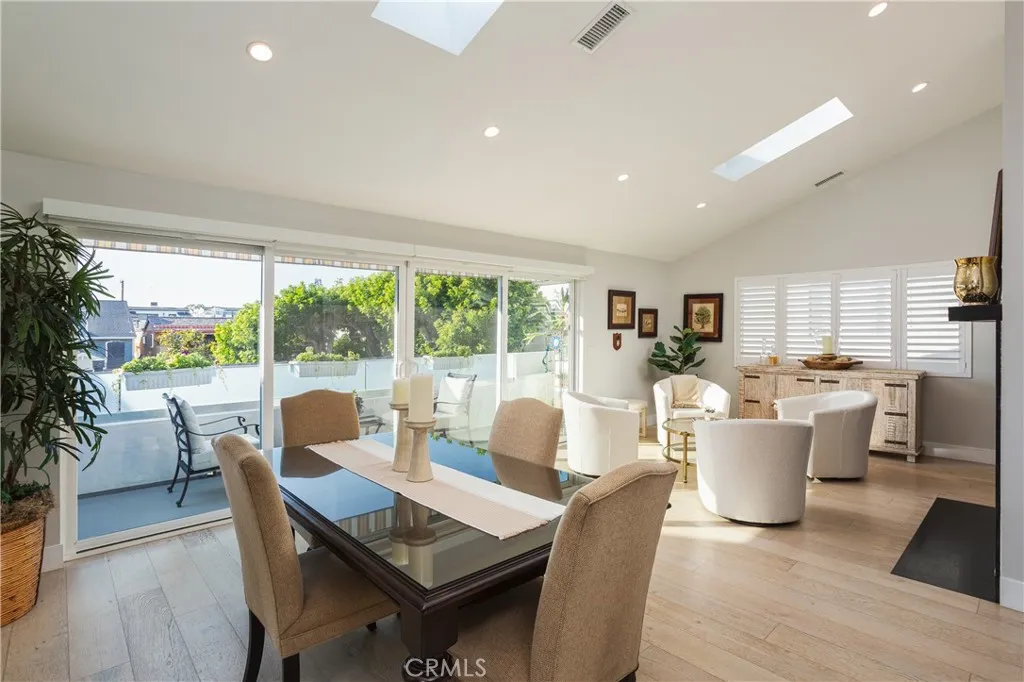 a living room with a large window and dining table