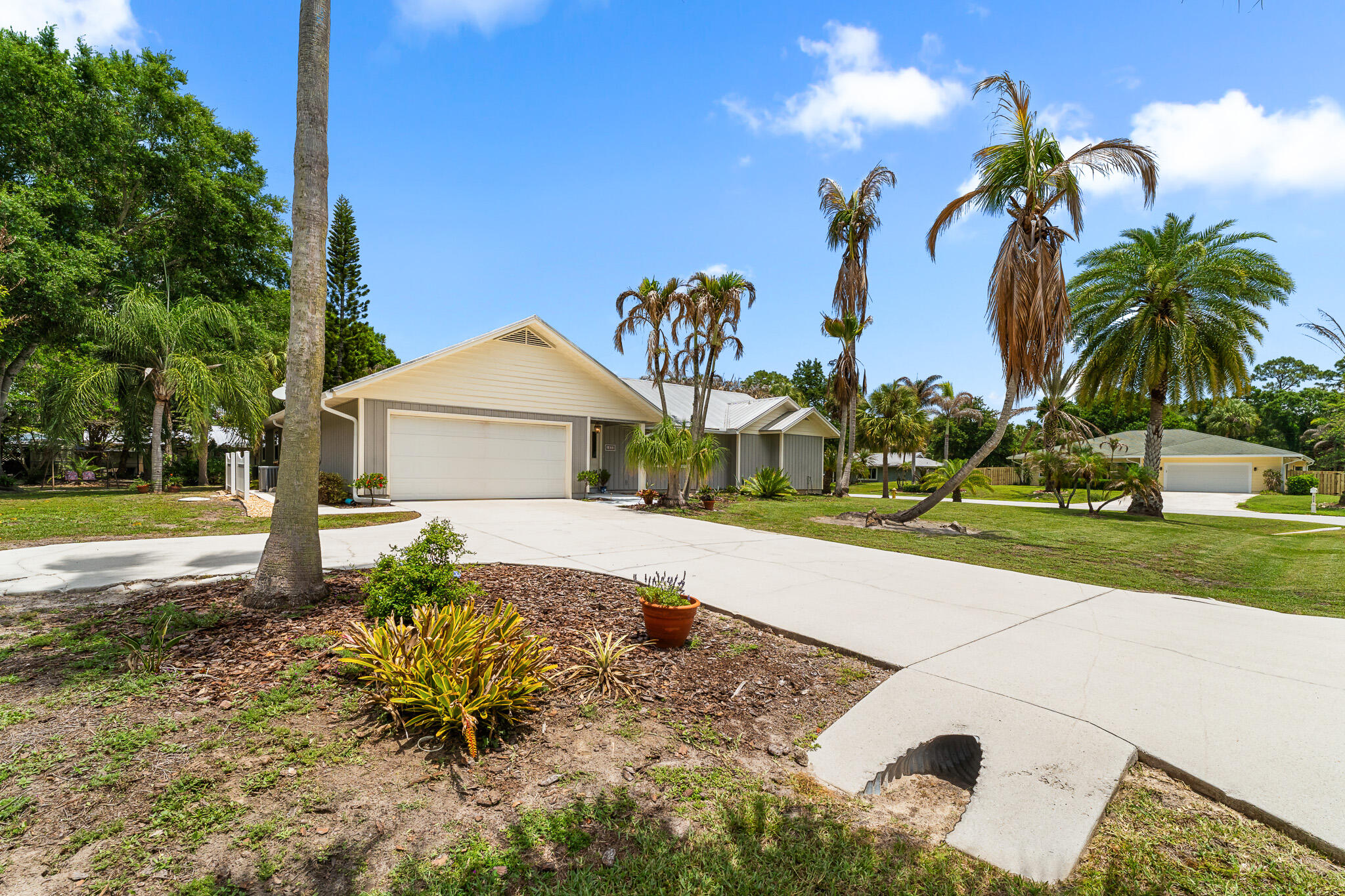 1653 Southwest 85th Terrace Stuart, FL 34997 - Photo 6 of 54 a front view of a house with garden